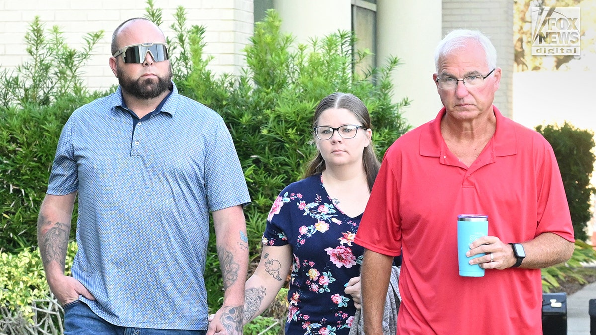 Chris Kepner, Shauntel Kepner, and Jeffrey Kepner walking into a courthouse in Melbourne, Florida
