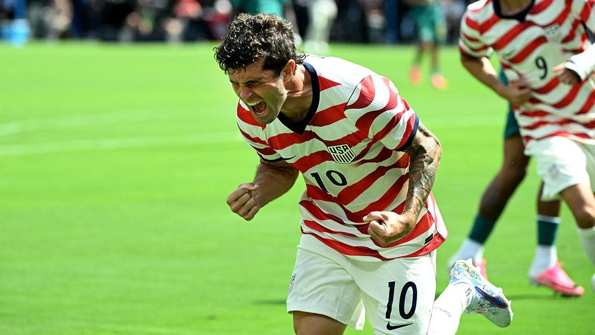 Christian Pulisic celebrating after scoring a goal at Bank of America Stadium