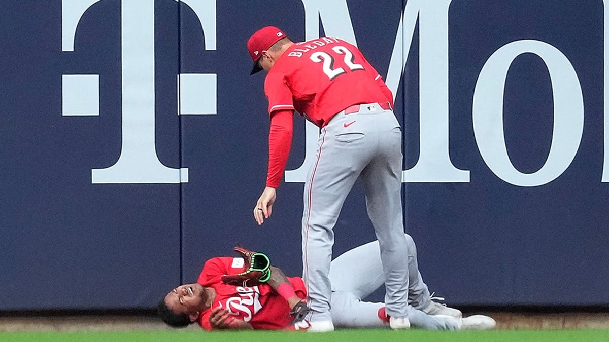Dane Myers lying injured on the field after colliding with the wall as JJ Bleday looks on at American Family Field.