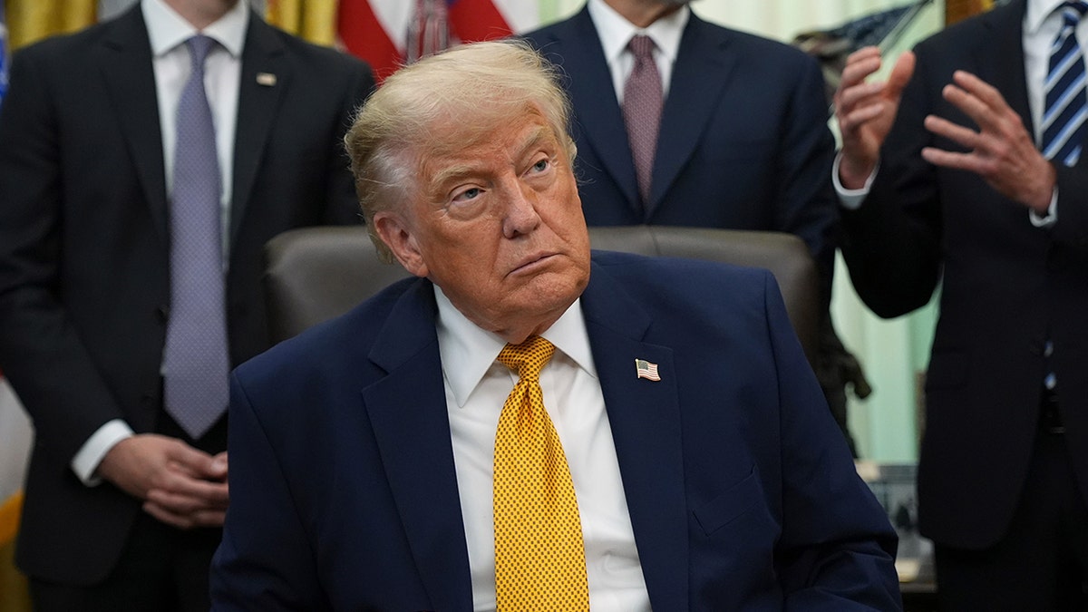 President Donald Trump signing an executive order in the Oval Office