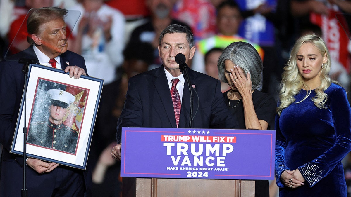 Republican presidential nominee Donald Trump holding a portrait of Nicholas Douglas Quets at a rally in Henderson, Nevada