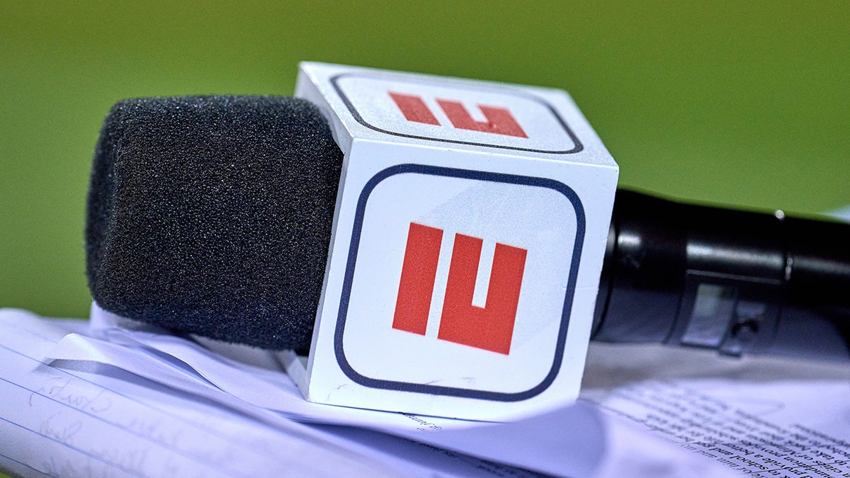 A microphone with an ESPN logo at Soldier Field during a football game.