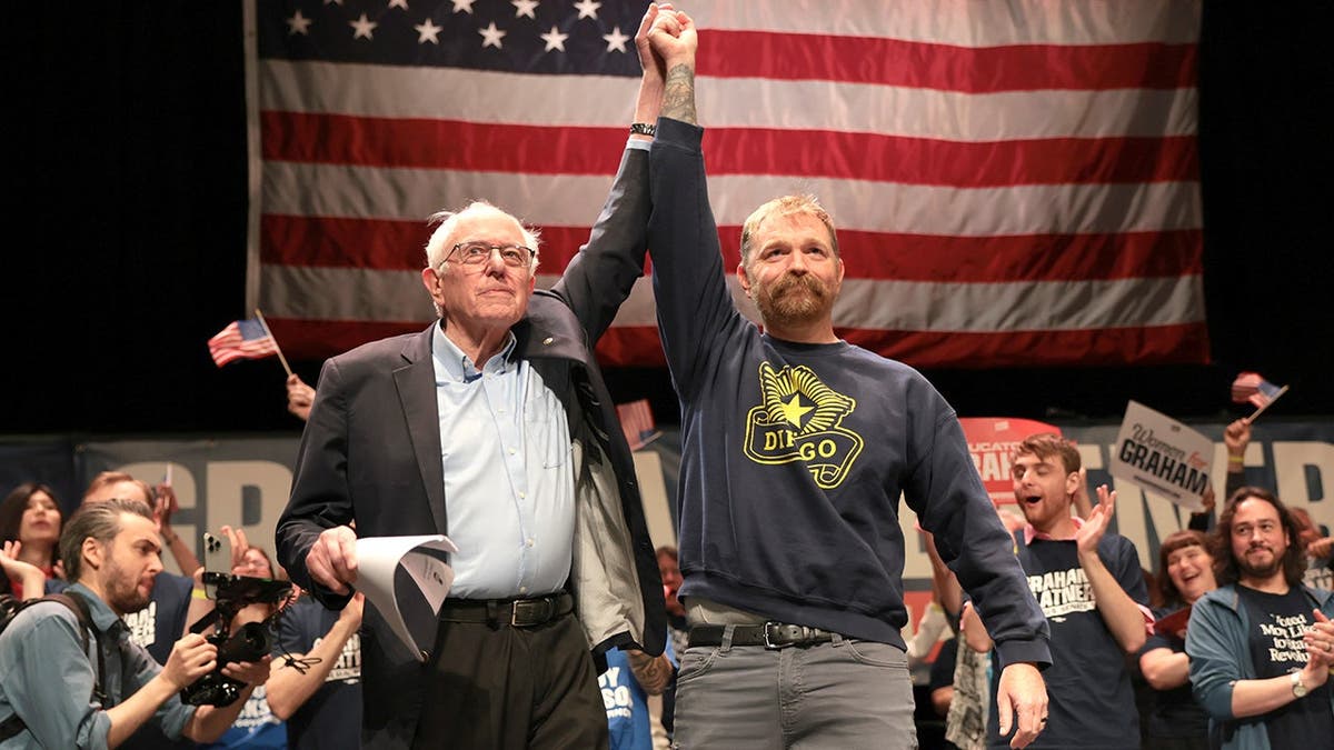 Bernie Sanders stands with Senate candidate Graham Platner at campaign event.