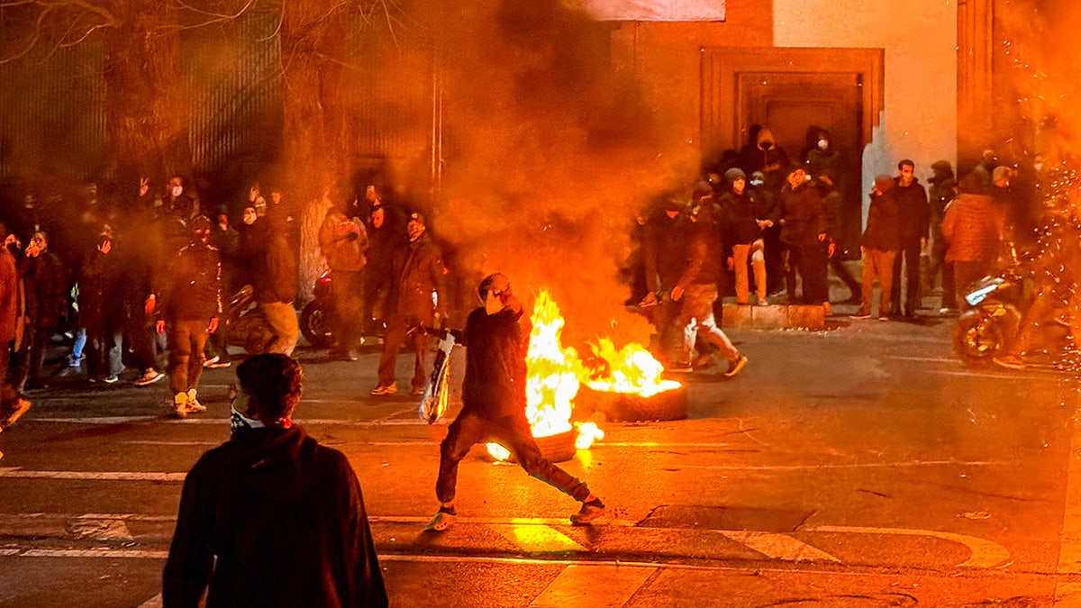 Protesters blocking a street during a demonstration in Tehran