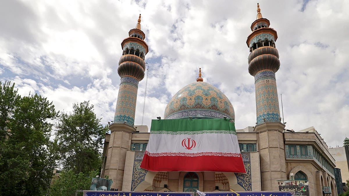 Iranian flag on mosque in Tehran