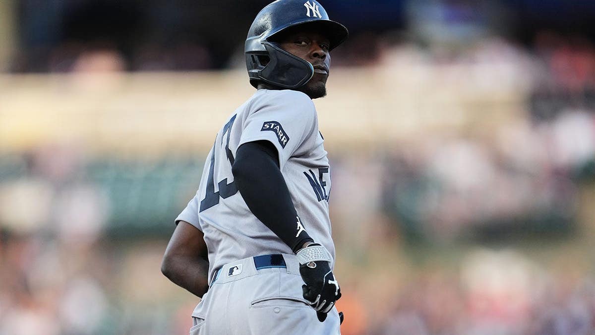 New York Yankees' Jazz Chisholm Jr. looking back at dugout after hitting home run.