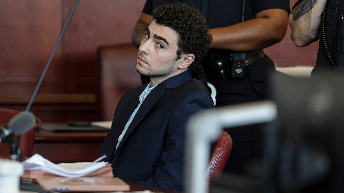 Luigi Mangione standing in a courtroom at Manhattan Supreme Court