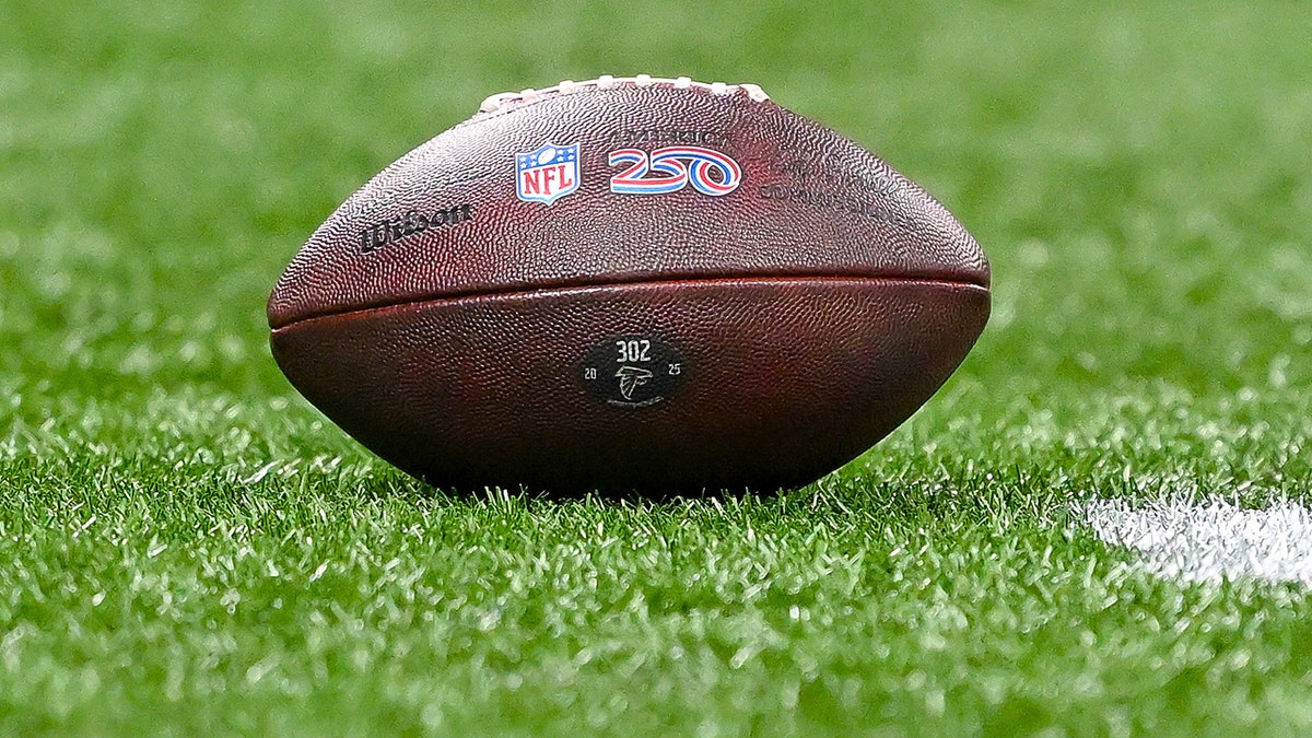 An NFL football with the 250 logo on a field at Mercedes-Benz Stadium in Atlanta, Georgia.