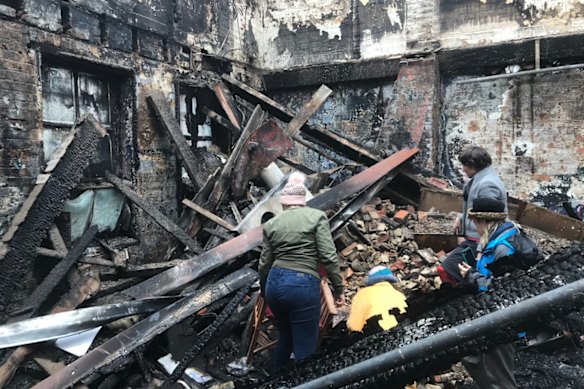 The aftermath of the La Mama Theatre fire in May 2018, which was caused by an electrical fault. Caitlin Dullard is pictured standing on the right.