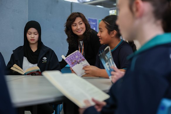 The Grange P-12 College core literacy co-ordinator Clara Tran with year 7 and year 8 students.