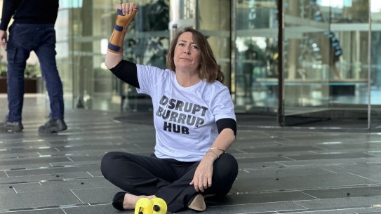 Disrupt Burrup Hub protester Kristen Morrissey outside Woodside’s headquarters after letting off “stench gas” in June 2023.