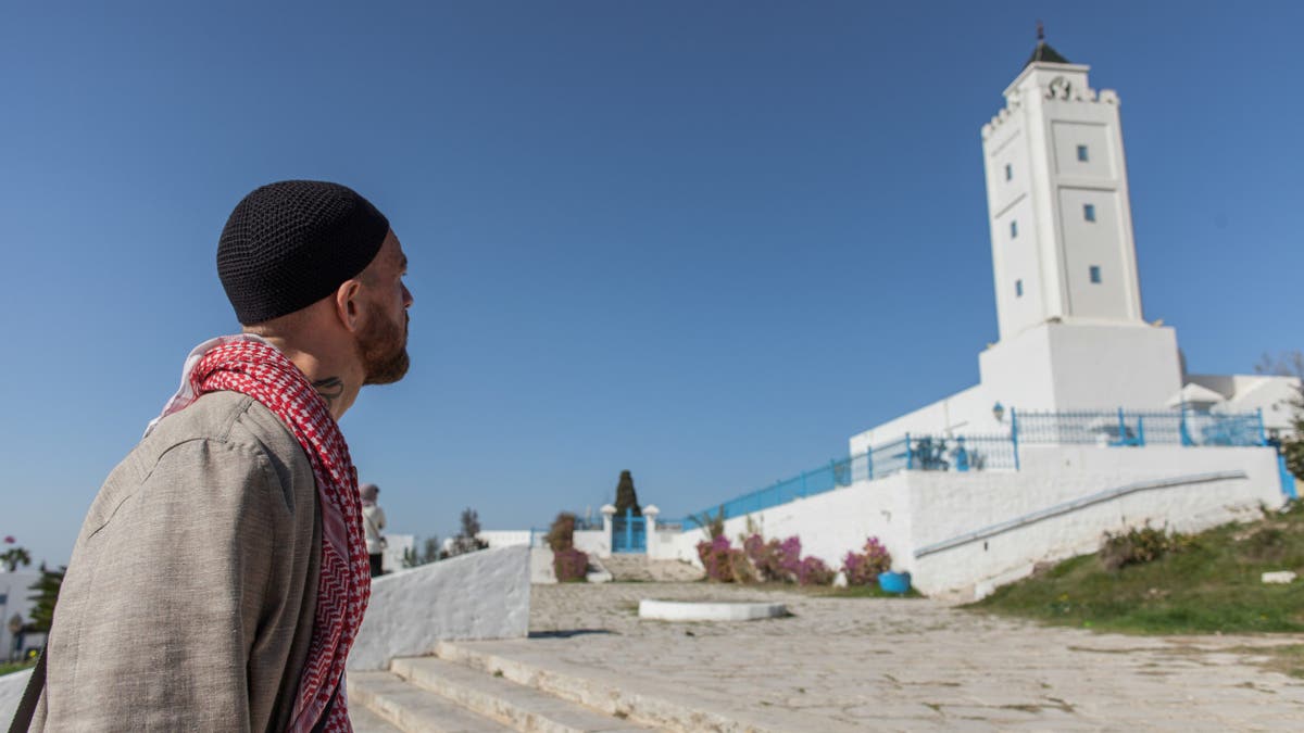 Fergie Chambers walks near a mosque in Tunis, Tunisia.