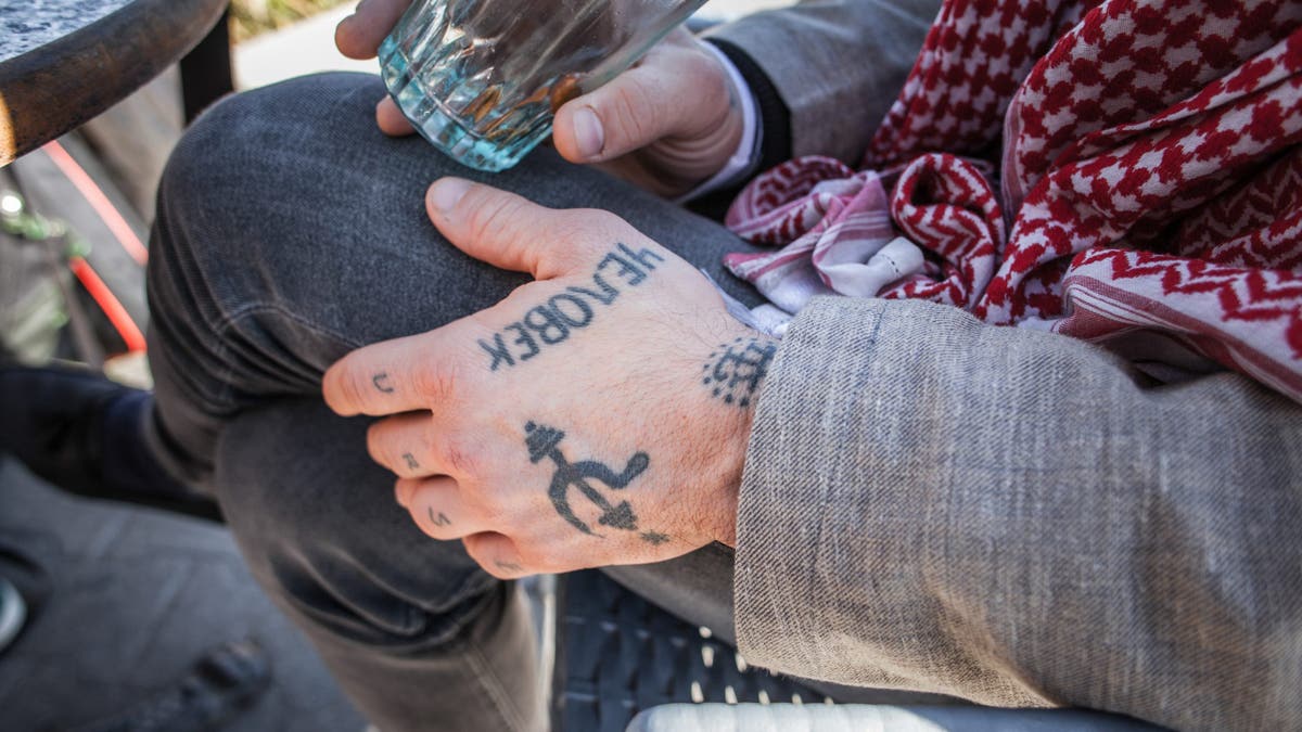 Fergie Chambers shows tattooed hands and fingers in a cafe in Tunis.