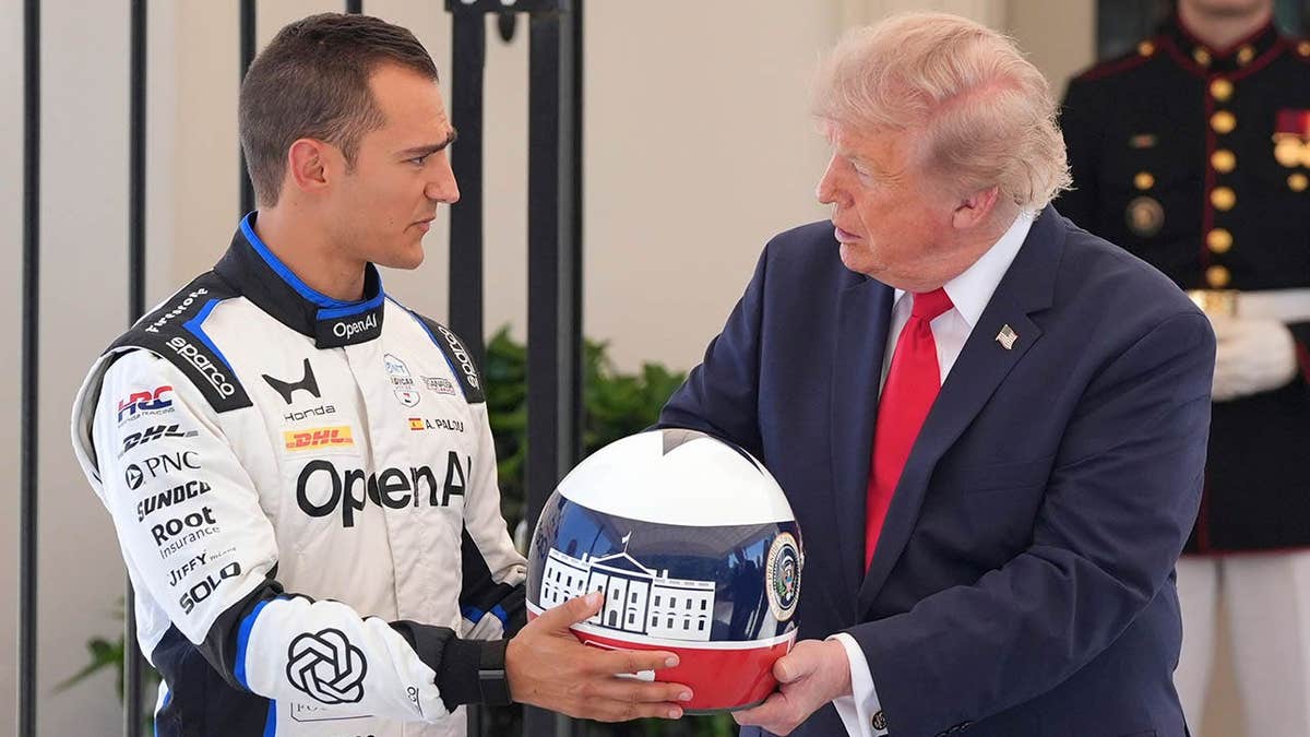 Alex Palou gifts President Donald Trump a helmet at the White House.