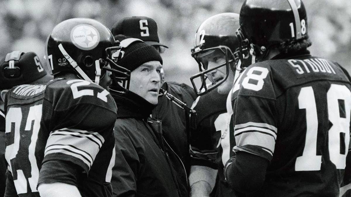 Chuck Noll talks with Terry Bradshaw, Cliff Stoudt and Greg Hawthorne on the sidelines.