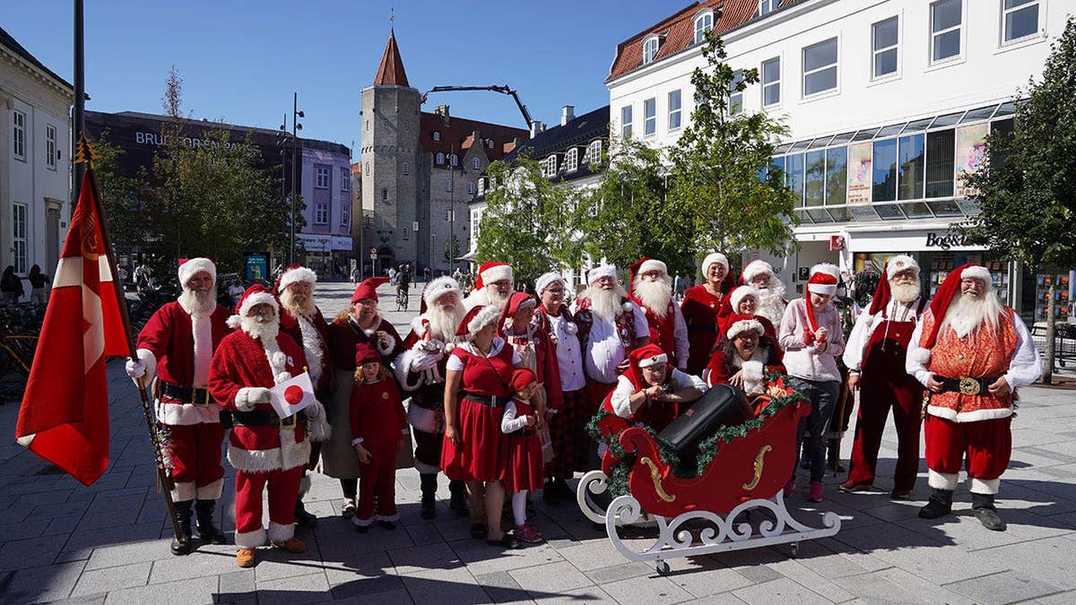 Santas, Mrs. Clauses and Christmas elves pose for a photo in Aalborg, Denmark.