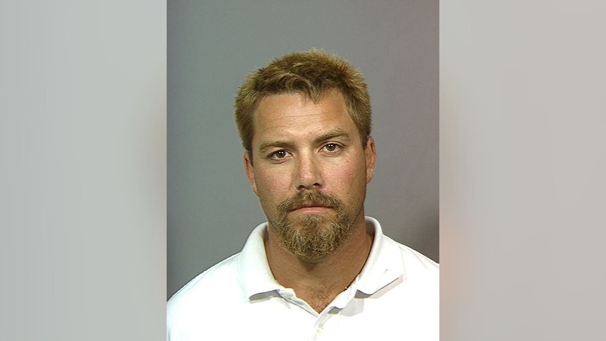 Scott Peterson stands after his arrest in Stanislaus County.