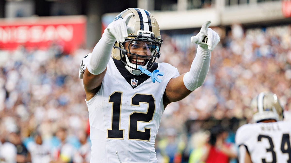 Chris Olave celebrates after scoring a touchdown during a Saints game.