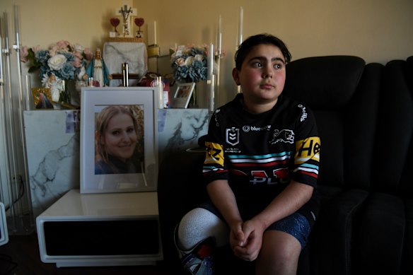 Sea World helicopter crash survivor Nicholas Tadros with a portrait of his late mother, Vanessa. 