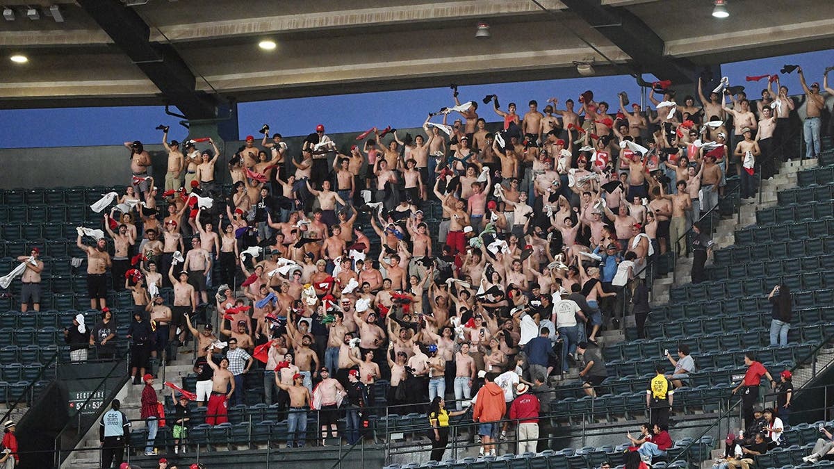 Fans in the stands chant 'Sell the Team' during an MLB game at Angel Stadium.