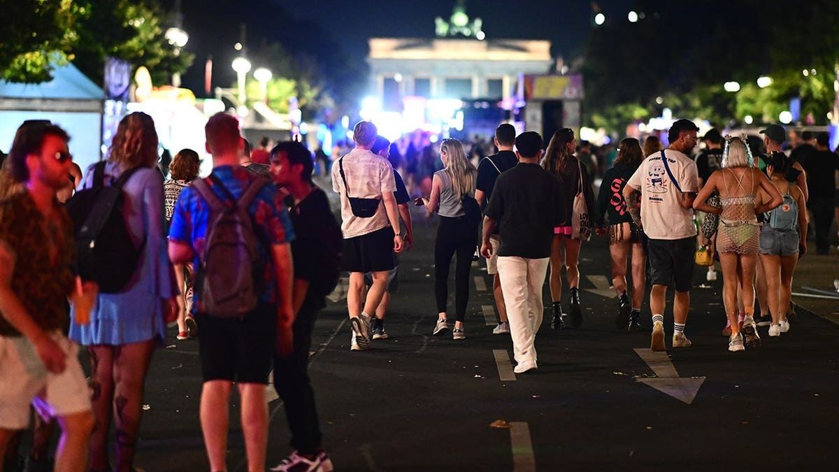 People stand on 17 June Street in Berlin following Christopher Street Day cancellation.