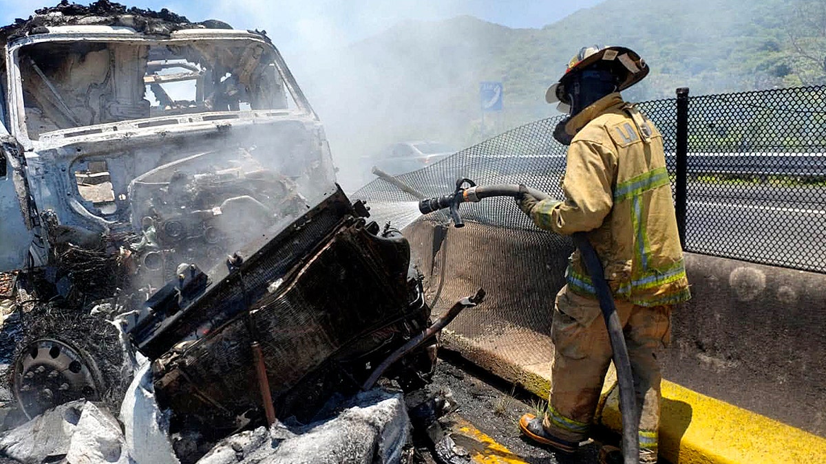 Firefighter spraying water on truck
