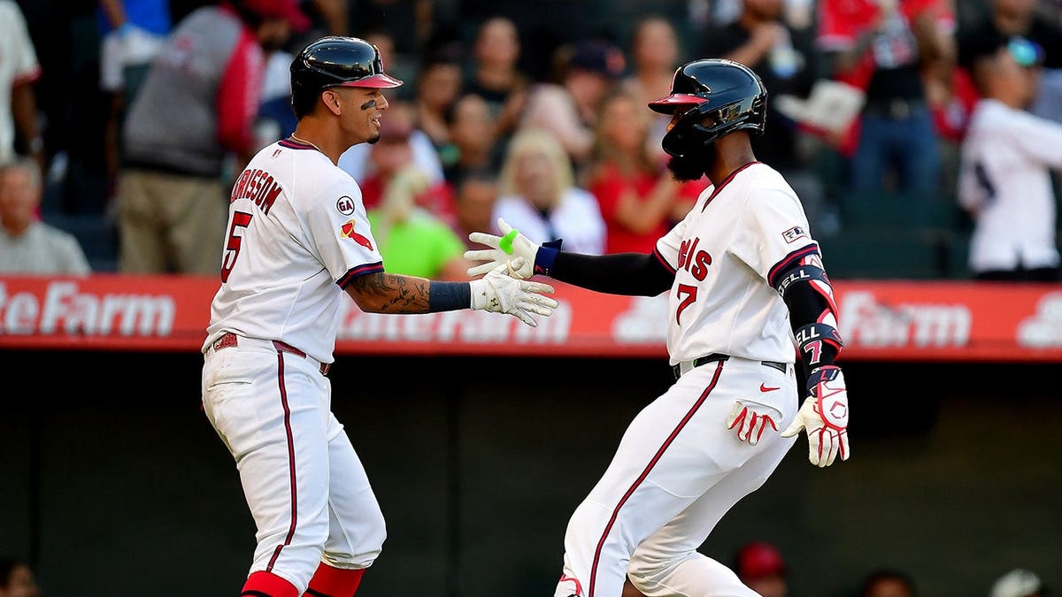 Jo Adell is greeted by Vaughn Grissom after hitting a home run at Angel Stadium.