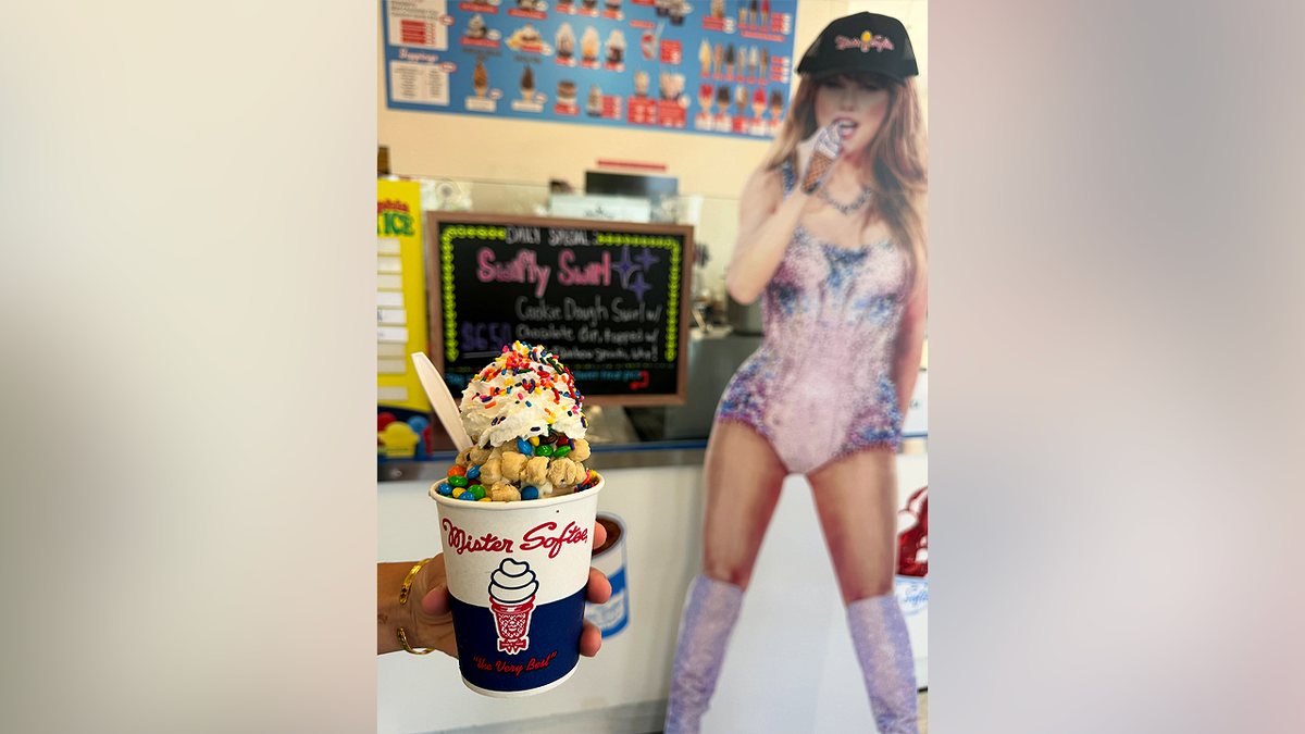 Mister Softee's Swiftie Swirl dessert is pictured in front of the Taylor Swift cardboard cutout before it was stolen