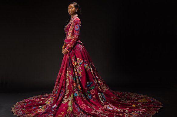 Embroiderer Lekazia Turner wearing The Red Dress - on show at the Museum of Brisbane.