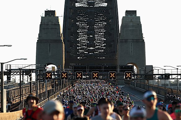 Joggers running across the Sydney Harbour Bridge in the 2025 Sydney Marathon.