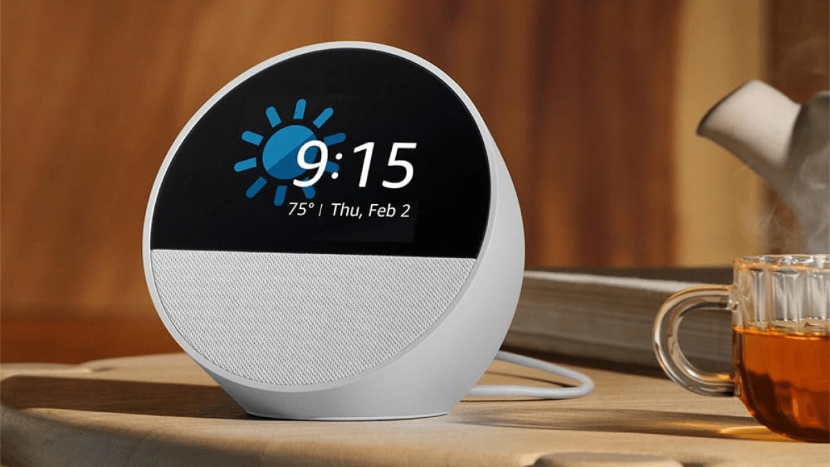 Amazon Echo Spot 2024 release on a nightstand with a cup of tea next to it.