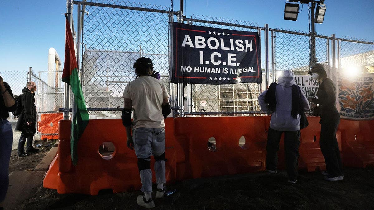 abolish ICE sign hands outside Delaney Hall