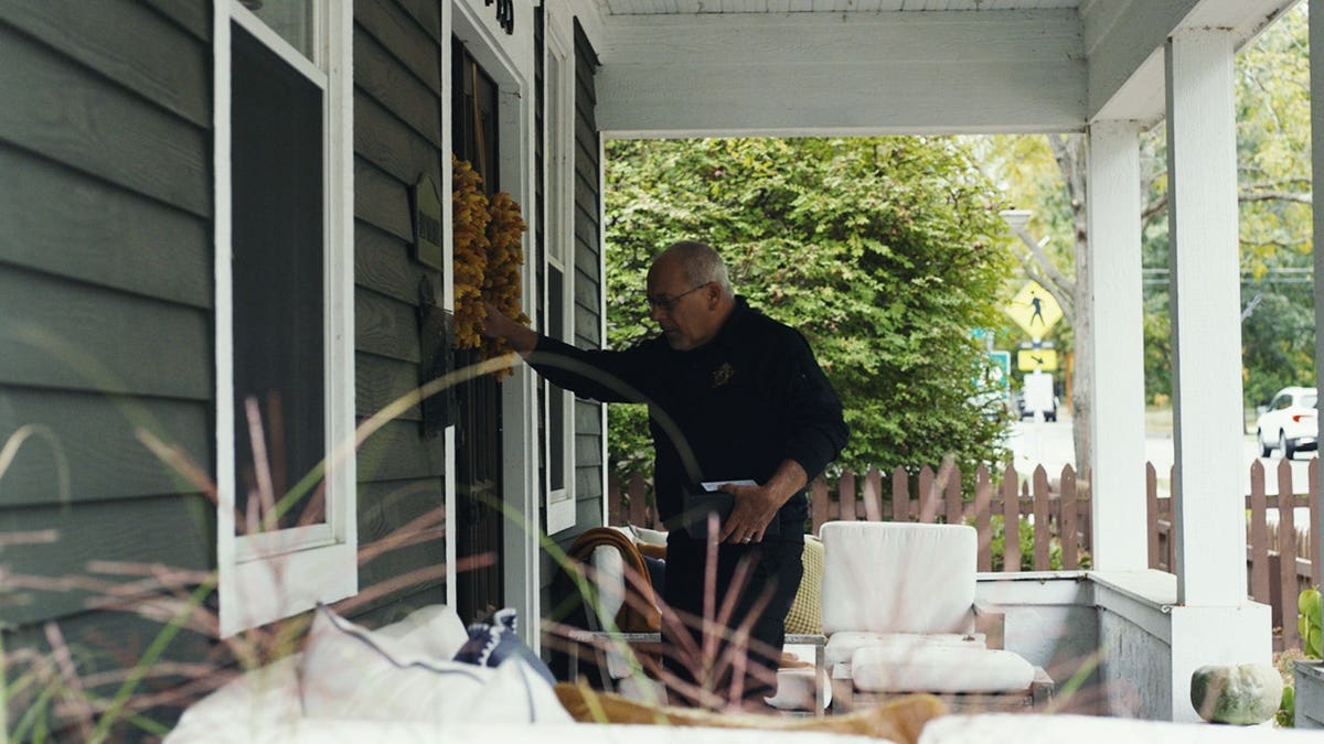 Jeff Jellison knocking on doors during an investigation.