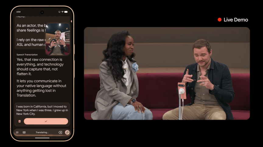 A woman listens while a man uses sign language to communicate to a phone that is translating it into text on a phone screen displayed at left.