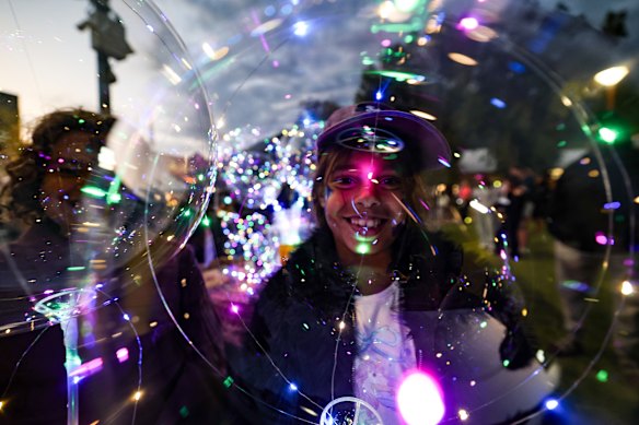 Telirah and Tamarni Lockyer enjoying their sparkly balloons at the Alice Springs night market.