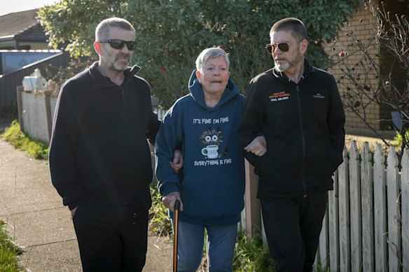 Pamela Delaney with two of her sons, Brendan (left) and Paul, in front of their former house in St Albans Park. In 1989, the area was part of Whittington.