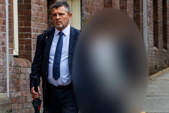 Lawyer John Sutton with one of the accused at court on Tuesday.