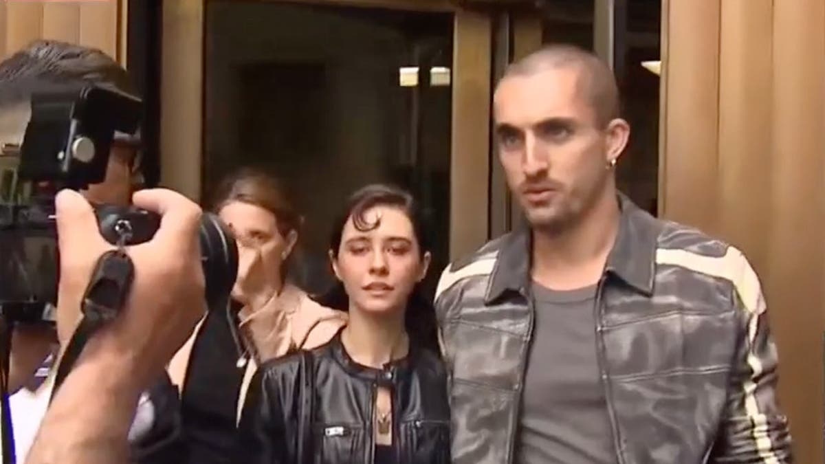 image shows couple walking outside courthouse
