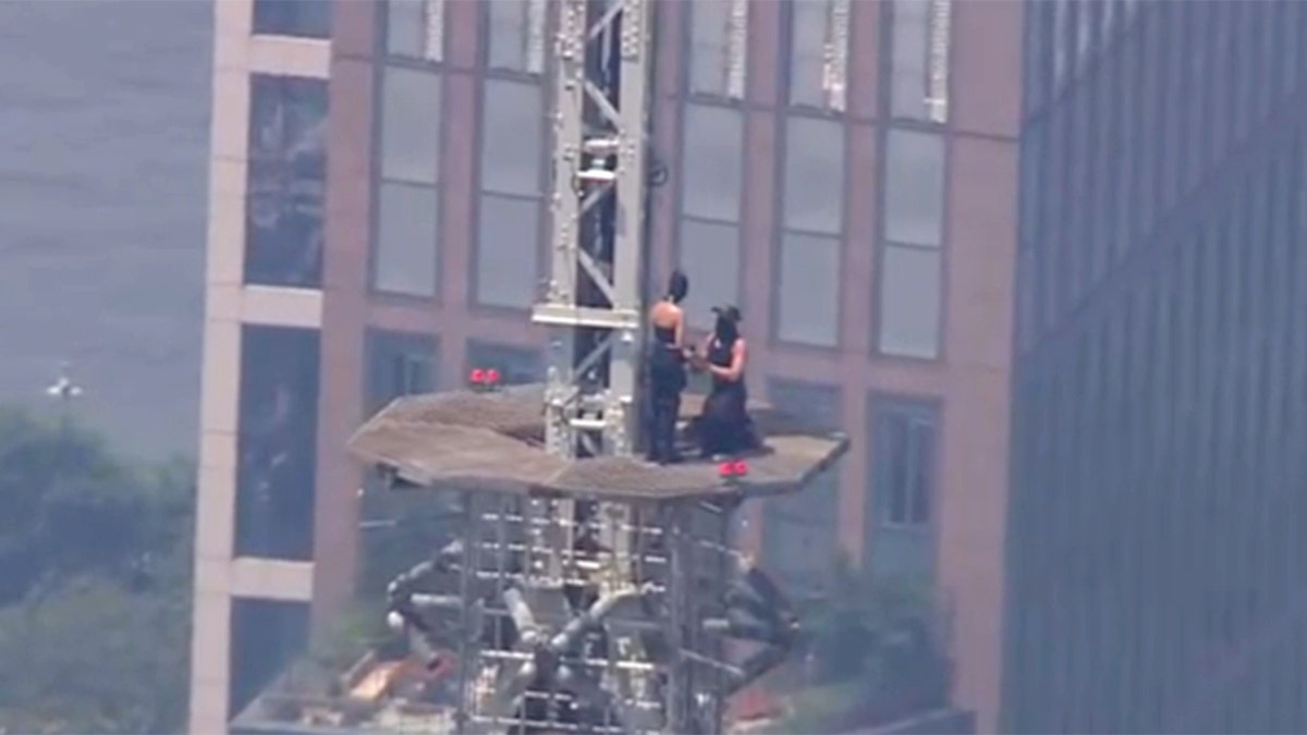 A person proposing on the Empire State Building spire