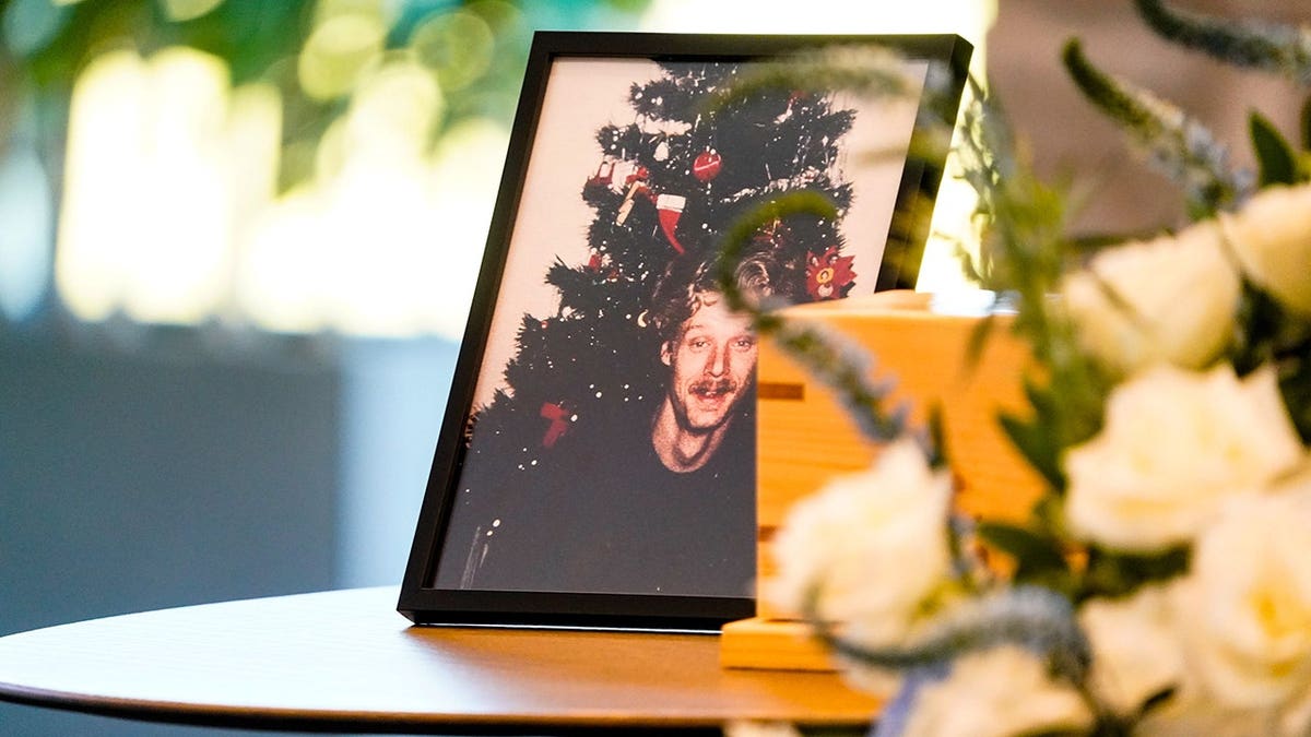 Allen Livingston's photo displayed next to his remains at a funeral service.