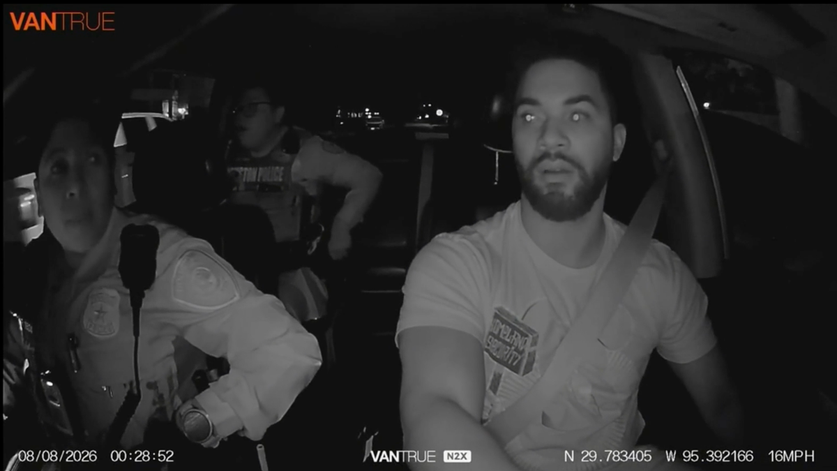 Houston Uber driver Anthony Baines drives while two officers ride in his vehicle during a nighttime pursuit