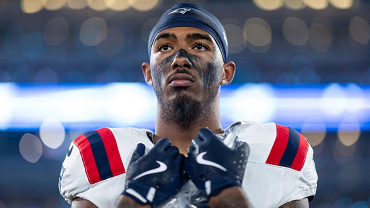 Ja'Lynn Polk of the New England Patriots looks on during the national anthem.