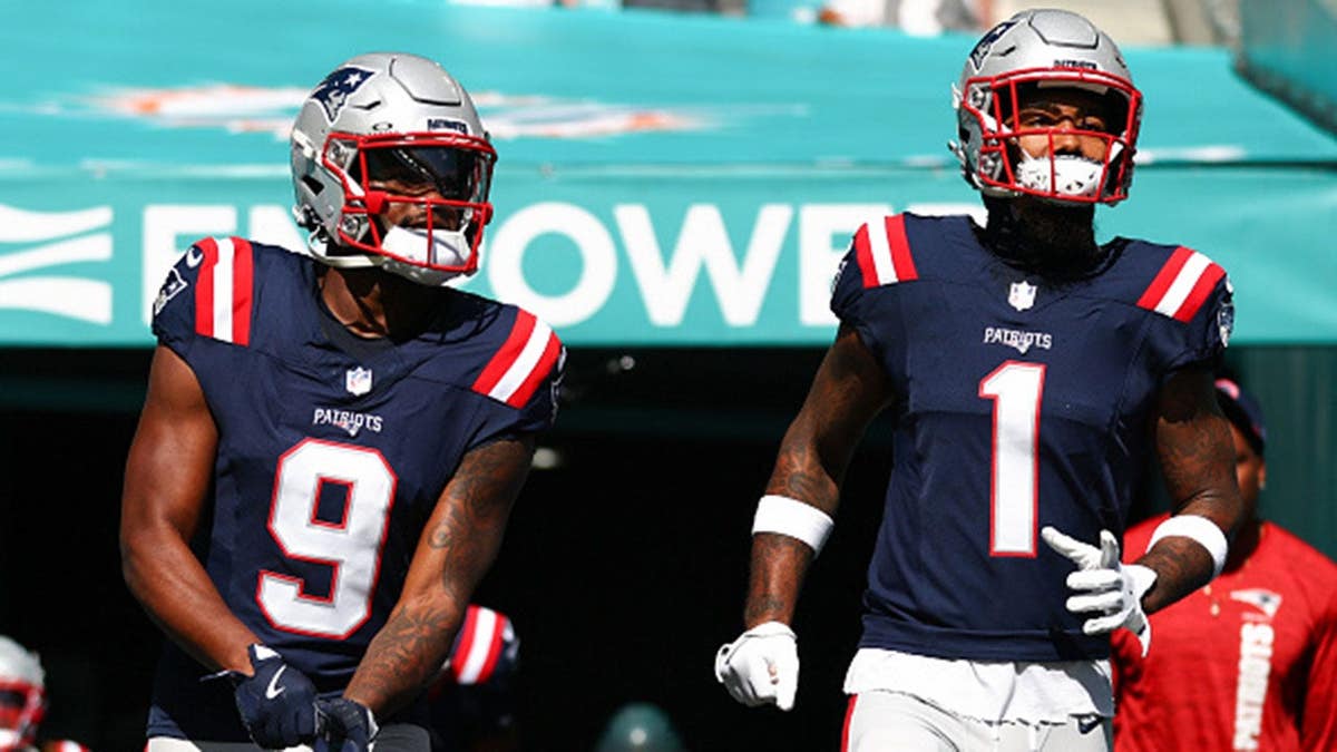 Kayshon Boutte and Ja'Lynn Polk of the New England Patriots take the field before a game at Hard Rock Stadium.