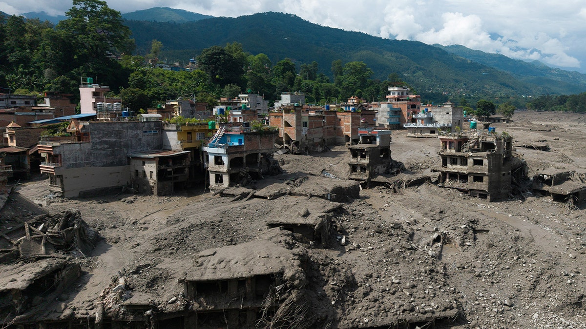A drone view shows mud covering properties following a flash flood at Trishuli in Nuwakot district, Nepal, August 26, 2026.