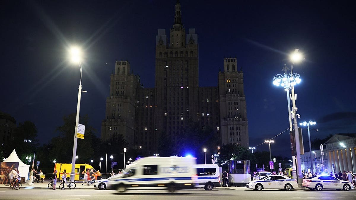 Police vehicles parked at the site of an explosion at a restaurant in Moscow.