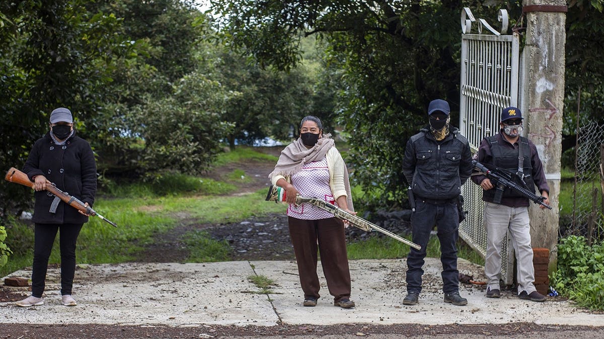 Members of Pueblos Unidos stand guard near avocado plantations in Ario de Rosales, Mexico.