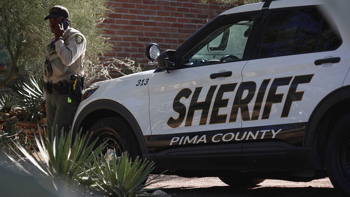 A Pima County sheriffs official stays outside of Nancy Guthrie‘s home on Saturday, Feb. 14, 2026 in Tucson, Ariz. (AP Photo/Ty O'Neil)