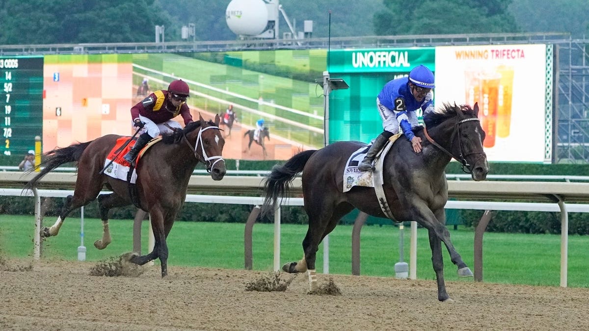 Sovereignty with Junior Alvarado leading Journalism with Umberto Rispoli down the front stretch at Saratoga Race Course