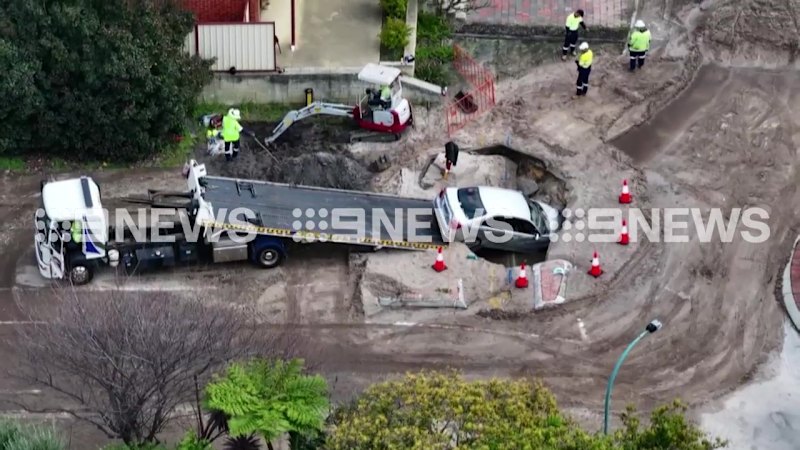 Driver escapes uninjured after car falls into sinkhole caused by burst water main in Perth’s south-east