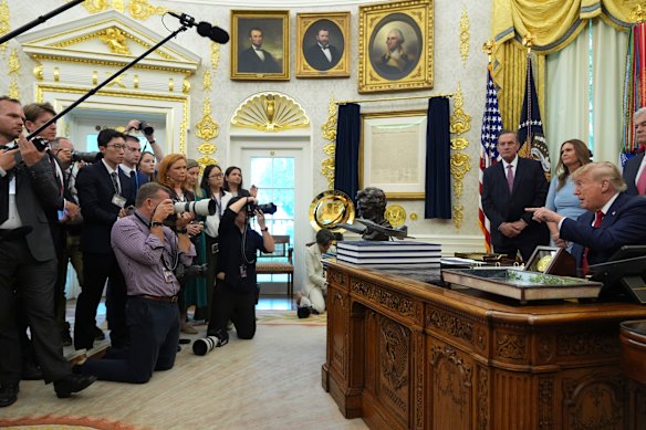 Donald Trump takes questions from reporters in the Oval Office on Friday after announcing a ban on CNN, Politico and MS-NOW.